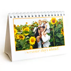 Personalised desk calendar featuring a family photo amidst sunflowers. The calendar has a white base with a spiral binding, making it perfect for office or home use. Ideal for gifts for men, Christmas gift ideas, or personalised gifts in South Africa.