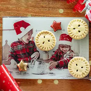 Personalised cutting board showcasing an adorable print of kids in Christmas outfits, adding a festive and joyful touch to holiday meal preparations.