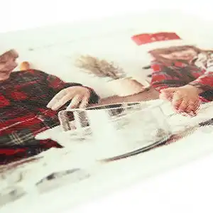 Close-up view of a personalised cutting board featuring a detailed print of kids dressed in Christmas outfits, highlighting the vivid colours and festive design.