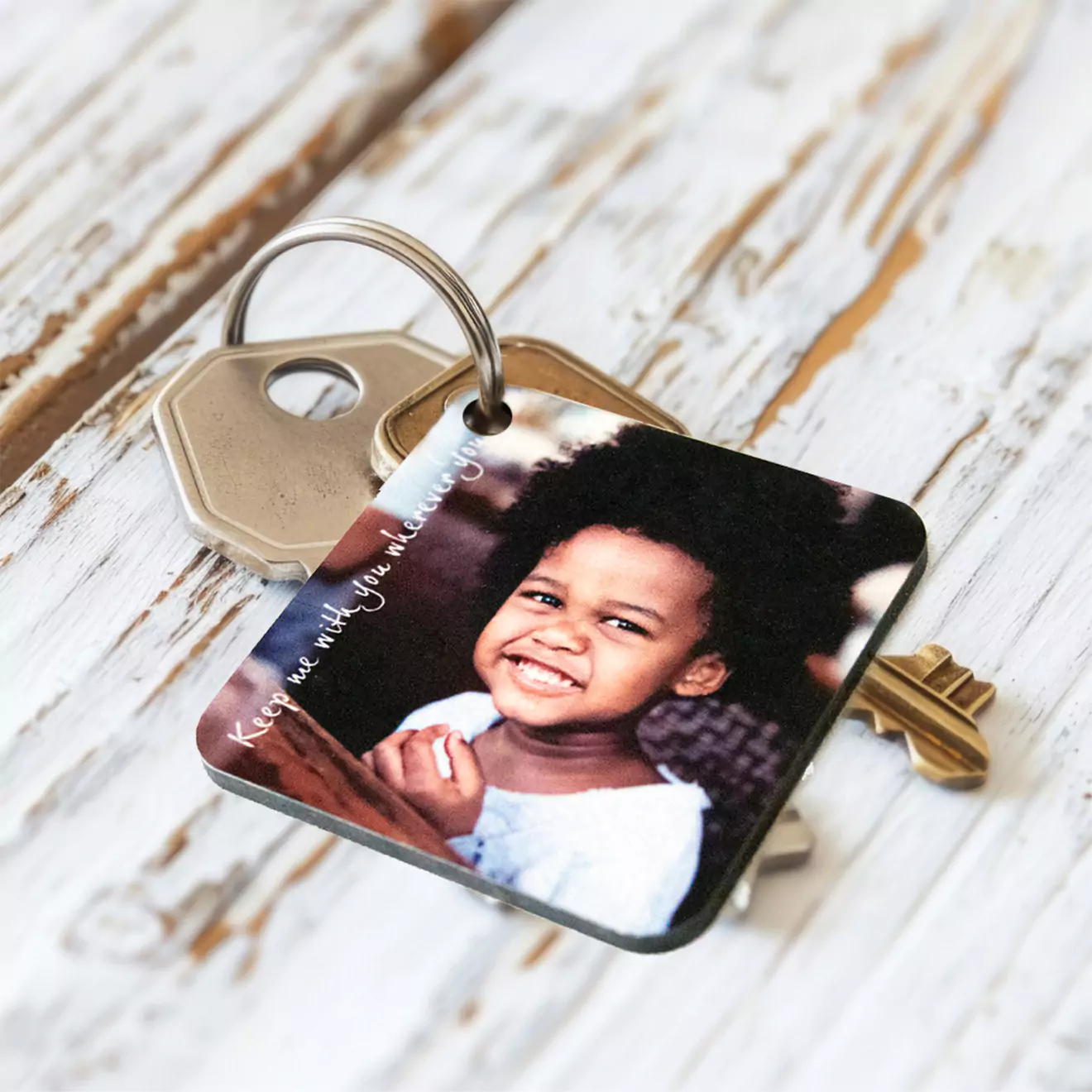 Personalised keyring held by a dad, showcasing a custom charm with a special photo or message, making it a meaningful gift that captures cherished family moments.