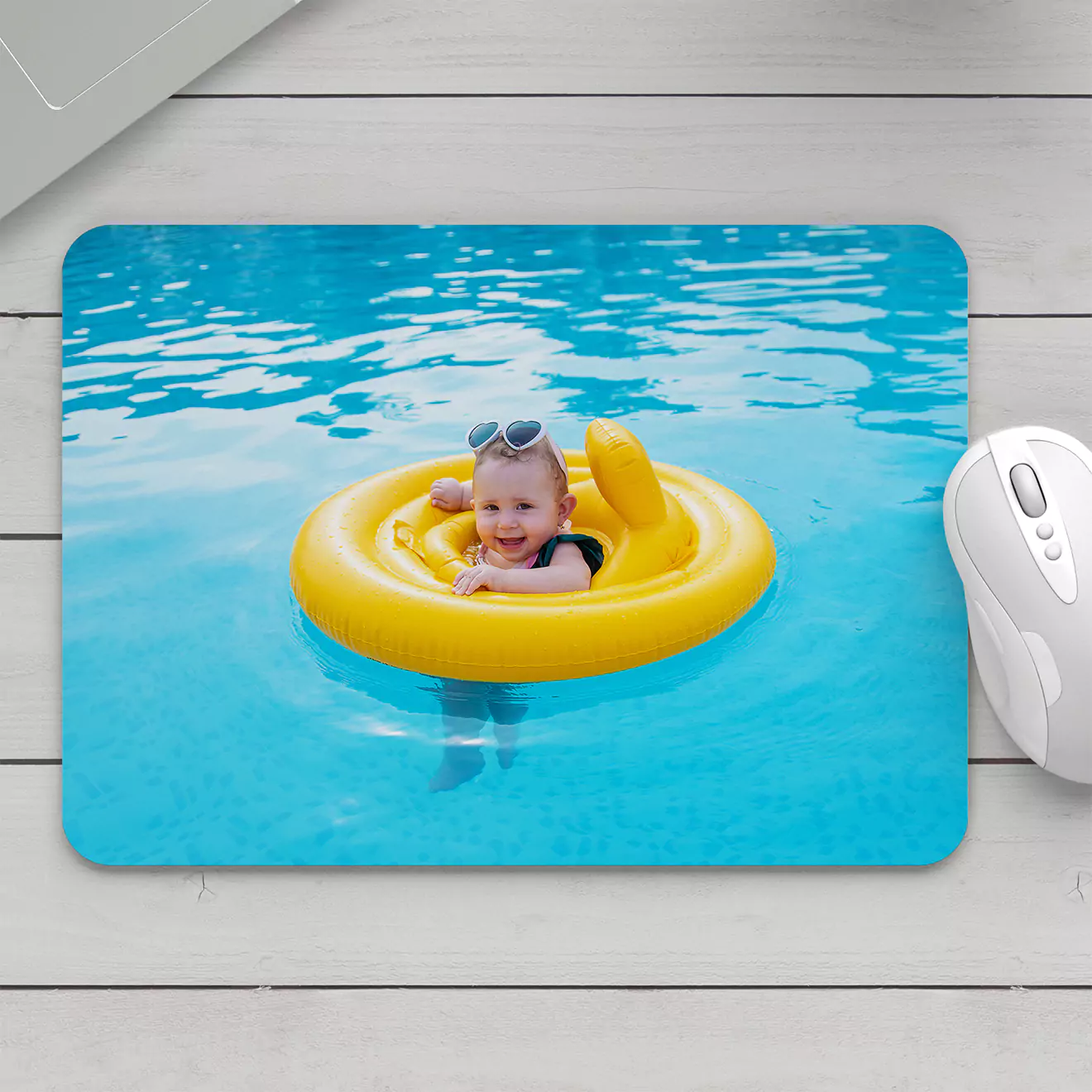 Vibrant mouse pad featuring a joyful image of a child playing in a pool, brightening up your desk space with a splash of fun and colour.