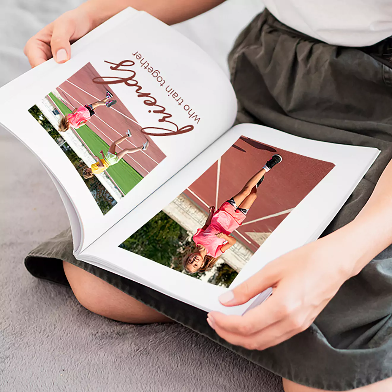 A person is sitting and holding an open photobook featuring images of children playing tennis on a court. The photobook has the word "friends" written in cursive on one of the pages.