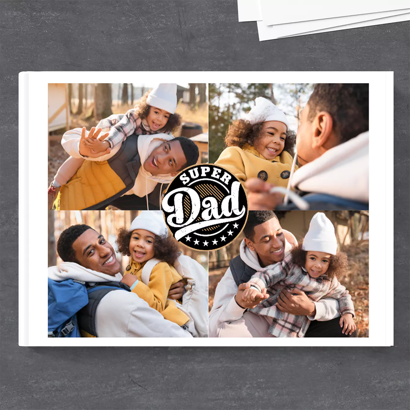 Photobook cover featuring a collage of a father and child enjoying playful moments outdoors. The center of the cover has a 'Super Dad' emblem, celebrating fatherhood.