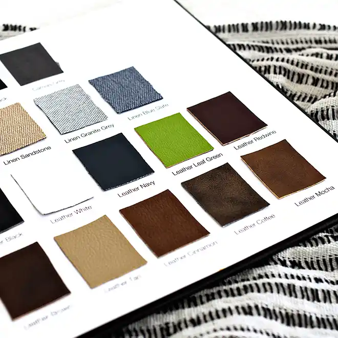 Open page of RapidStudio’s sample album displaying swatches of different cover materials, from leather to various paper finishes, providing a tactile selection guide for clients.