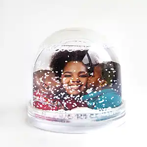 Personalised snow globe featuring a photo of a mother and her two children inside, with sparkling snow falling around them, perfect for capturing and cherishing family moments.