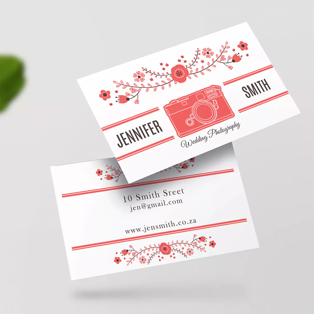 Elegant personalised business cards for a wedding photographer, featuring a floral design and a vintage camera illustration in red. Includes contact details and website, perfect for professional branding.