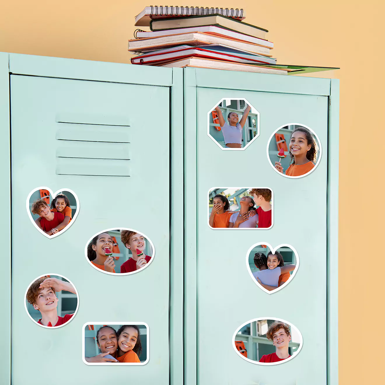 Light blue lockers adorned with various shaped photo magnets featuring smiling faces, perfect for personalising school or office spaces. A stack of books rests on top of the lockers.