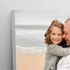 Premium canvas print featuring a heartwarming photo of a young girl hugging an adult male, both smiling. The background showcases a serene beach scene. Ideal for personalised gifts in South Africa, this canvas is perfect for Christmas gifts, baby shower gift ideas, or gifts for dad.