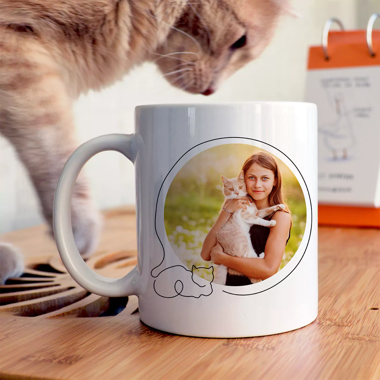 White ceramic mug featuring a personalised photo of a woman holding a cat, with a minimalist cat outline design. Ideal for cat lovers and makes a thoughtful gift for her. Perfect for occasions like birthdays, Christmas, or as a unique personalised gift in South Africa.