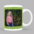 White ceramic mug with a green-themed design featuring a personalised photo of a young girl in a striped shirt and jeans, standing in front of lush greenery. Ideal for personalised gifts in South Africa, perfect for occasions like Christmas, birthdays, or baby showers.