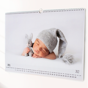 Personalised wall calendar featuring a photo of a sleeping baby wearing a grey knitted hat, holding a small stuffed animal. The calendar is spiral-bound at the top, with a clean, minimalist design. Ideal for baby shower gift ideas, Christmas gifts, or personalised gifts in South Africa.