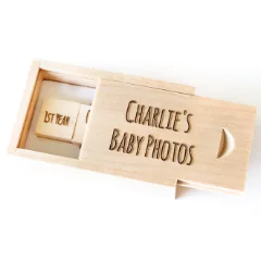 Wooden USB drive in a sliding wooden box engraved with "Charlie's Baby Photos." The USB drive is also engraved with "1st Year." Ideal for storing and gifting baby photos, making it a thoughtful baby shower gift idea or personalised gift. Suitable for photo albums and keepsakes.