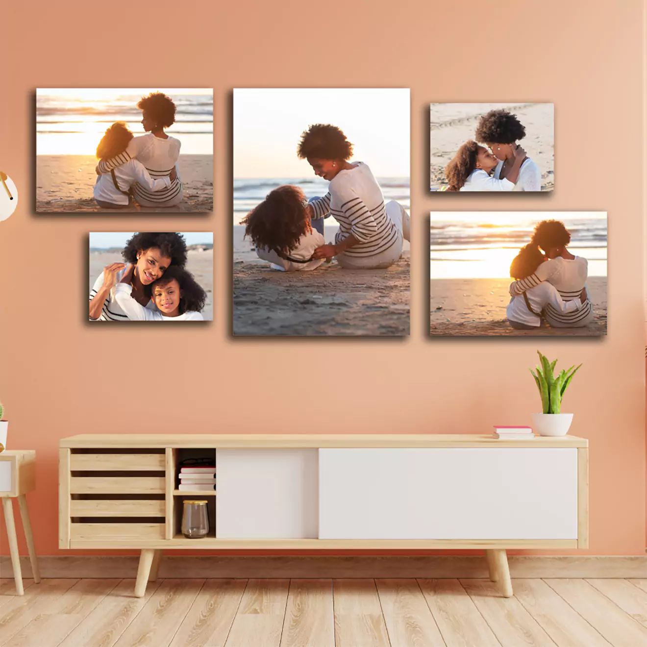 A set of five personalised canvas prints displayed on a peach-coloured wall above a modern wooden console table. The canvases feature heartwarming family moments on a beach at sunset, ideal for home decor or as thoughtful gifts for special occasions such as Christmas, Valentine's Day, or birthdays.