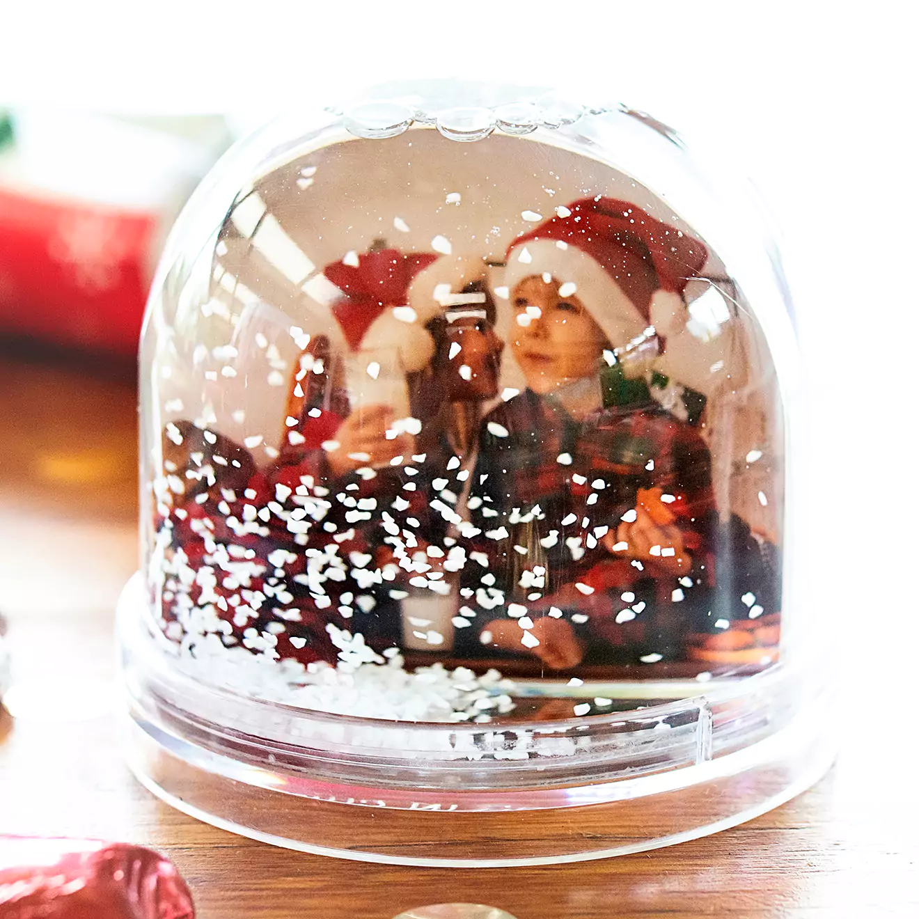 Image of a personalised snow globe from RapidStudio, encapsulating a custom photo amidst floating snow or glitter, creating a magical display of cherished moments.