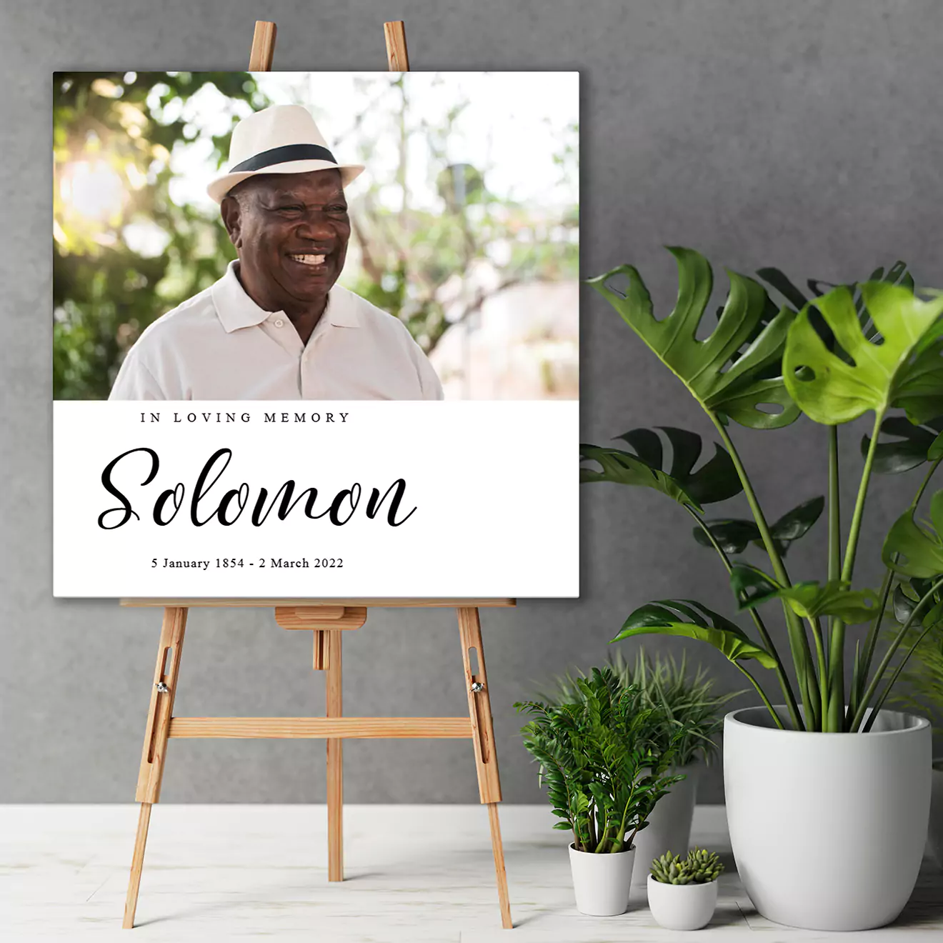 Personalised canvas print featuring a young child playing in the sand, wearing a blue hat and blue shorts. The canvas is displayed on a wooden shelf next to a potted cactus, making it a charming and heartwarming decor piece. Ideal for gifts such as baby shower, Christmas, or Valentine's Day.