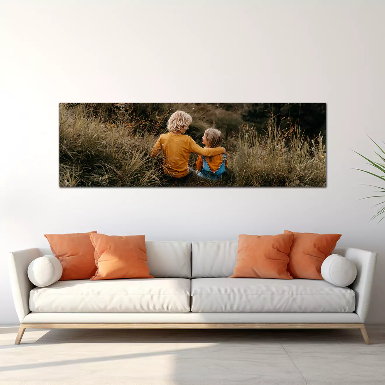 Modern living room with a yellow sofa adorned with brown and beige cushions. Above the sofa, a large, personalised canvas print features a joyful couple in casual attire, with a bright and airy outdoor background. Ideal for home decor and personalised gifts in South Africa.