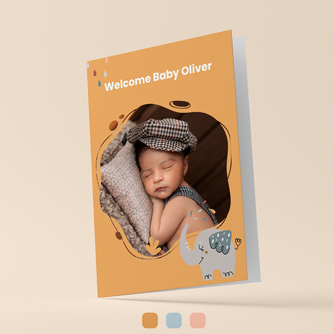 A baby greeting card with a warm orange background featuring a photo of a sleeping baby wearing a checkered cap. The card has the text "Welcome Baby Oliver" at the top and an illustration of a cute elephant at the bottom. Ideal for baby shower gift ideas and personalised gifts in South Africa.