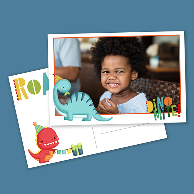 Personalised photo card featuring a smiling child, adorned with playful dinosaur illustrations in blue and red, wearing party hats. The card includes colourful text "ROAR" and "DINO MITE!" making it a fun and vibrant choice for baby shower gift ideas, children's birthday invitations, or Christmas gifts.