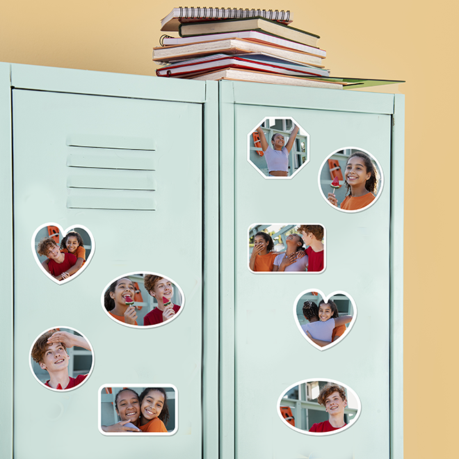 Light blue locker decorated with various shaped photo magnets featuring smiling individuals. The magnets are heart, oval, and rectangular shaped, showcasing personalised photo memories. A stack of books is placed on top of the locker. Ideal for personalised gifts in South Africa.