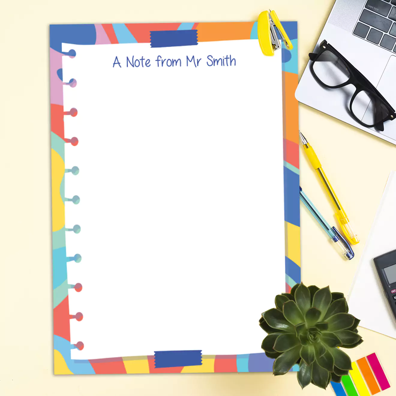 Colourful notepad with a playful, multi-coloured border and the text "A Note from Mr Smith" at the top. The notepad features a fun, zany design with a faux torn paper edge. Ideal for personalised gifts, teacher gifts, or creative note-taking. Shown on a desk with stationery and a plant.