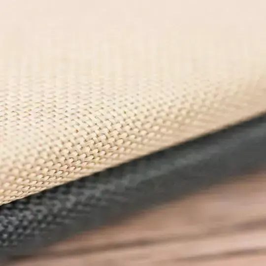 Close-up image of a textured photo album cover featuring a beige fabric material on top and a black fabric material underneath. The detailed weave of the fabric is visible, highlighting the quality and craftsmanship. Ideal for personalised gifts, photo books, and special occasions.