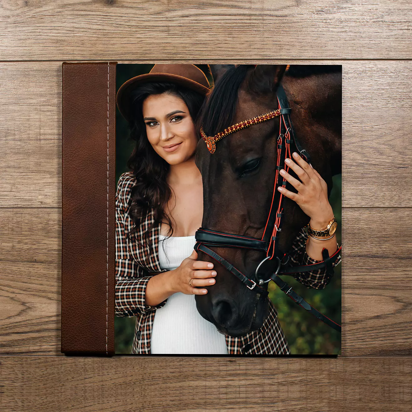 Elegant photo album featuring a romantic wedding scene on the cover, with a couple embracing outdoors surrounded by floral arrangements. The album has a black spine and a high-quality, glossy finish. Ideal for preserving wedding memories, making it a perfect gift for newlyweds or anniversaries.