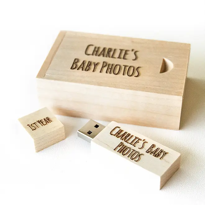 Wooden USB drive and box set engraved with "Charlie's Baby Photos." The set includes a USB drive and a matching wooden box, both in a light wood finish. Ideal for storing and gifting baby photos. Perfect for baby shower gift ideas, personalised gifts, and photo storage solutions.